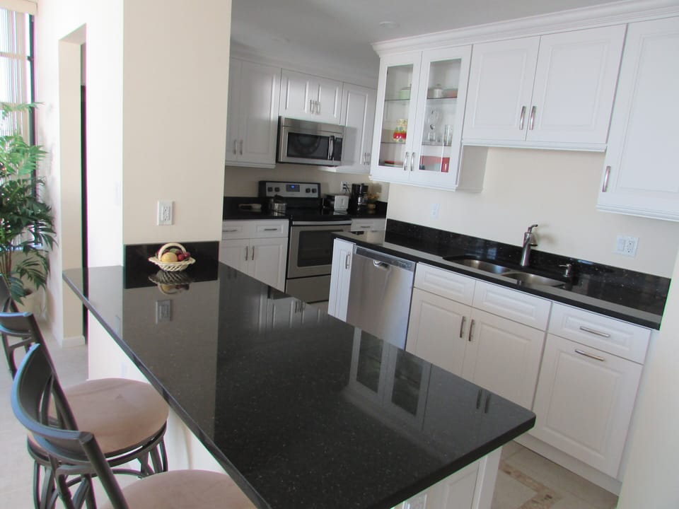 Island reakfast bar & all new kitchen cabinets, counter top, appliances & tile.