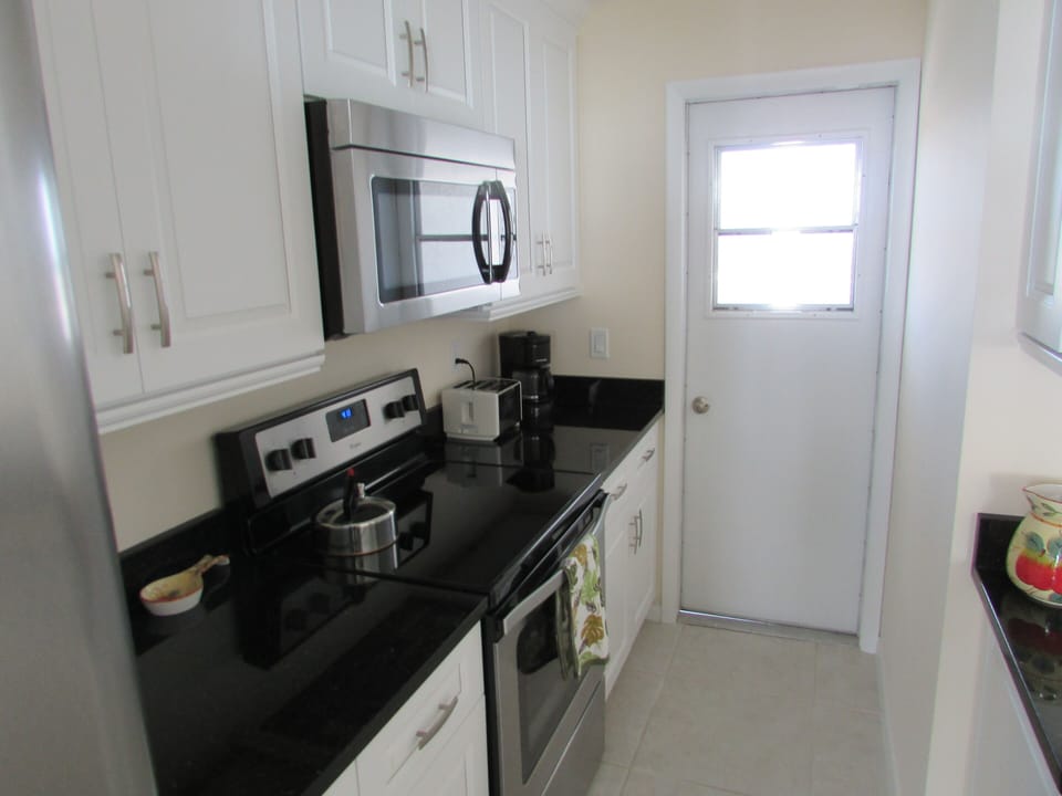 All new granite counter tops. Door off of kitchen to small rear balcony.