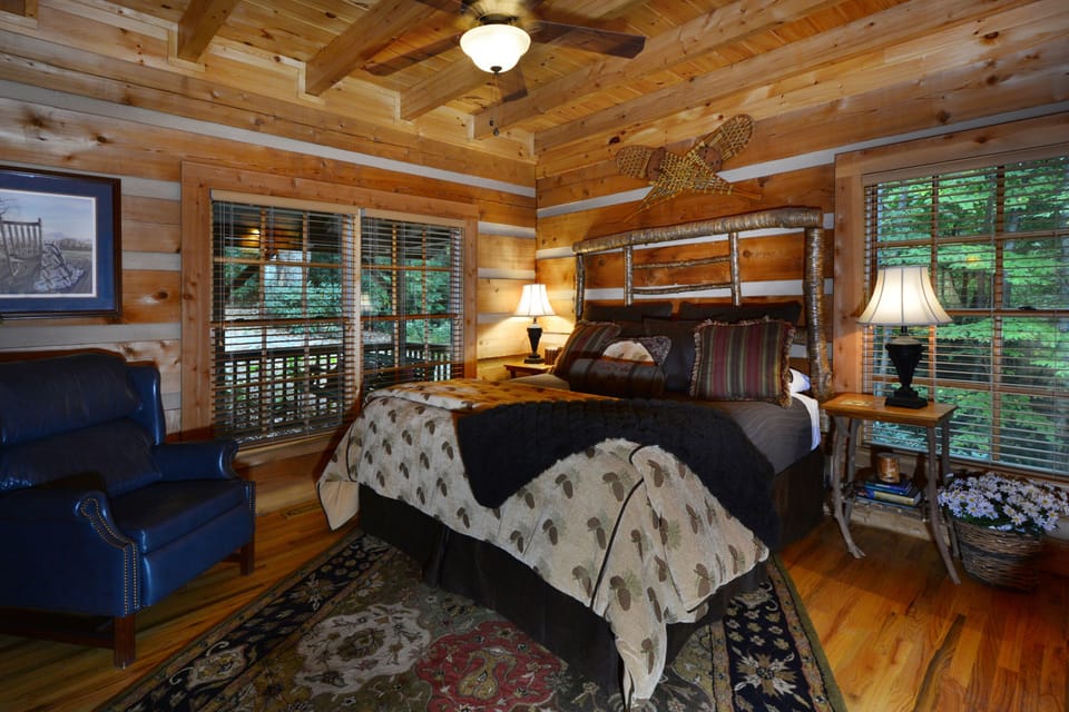 Rustic Master Bedroom with king bed, private bath, ceiling fan, and new 55" HDTV