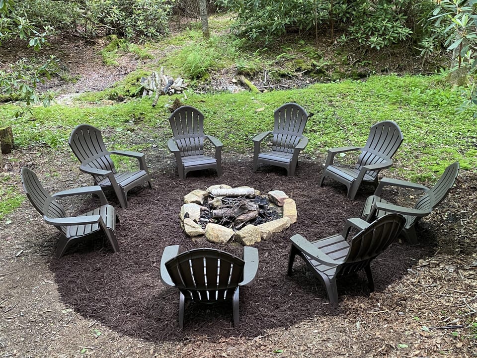 Fire pit by the brook with chairs; just steps from the cabin