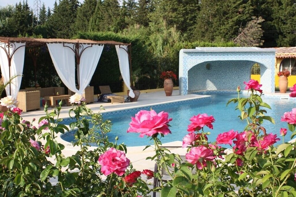 pool with garden furniture and deck chairs