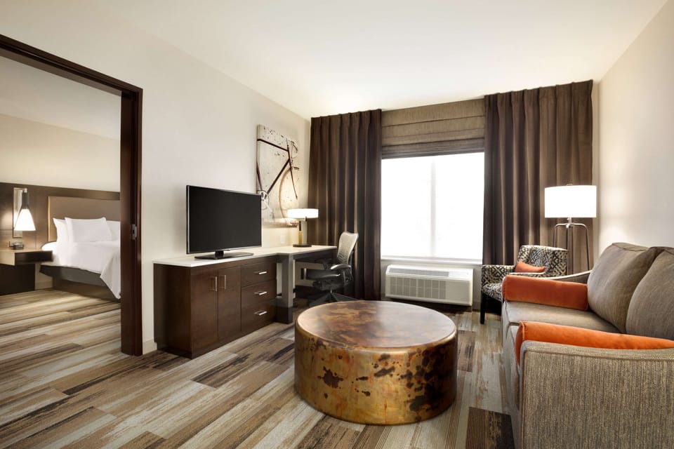 Premium bedding, desk, laptop workspace, blackout drapes