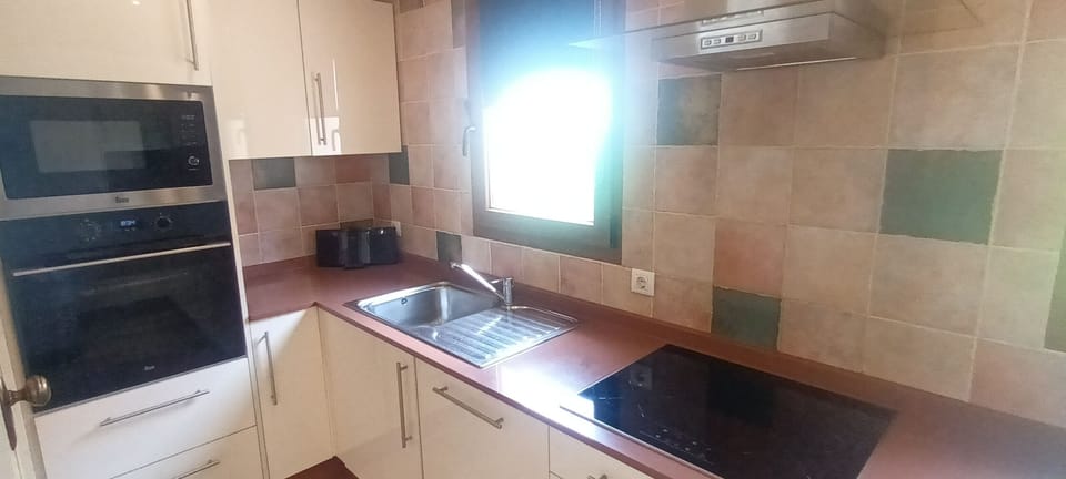 Kitchen fully kitted out including oven, hob, dishwasher, microwave.