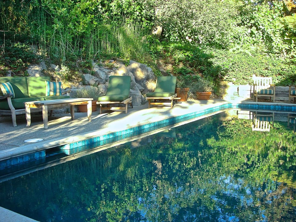 Enjoy the quiet serenity  around the pool and take in the lush landscape. 