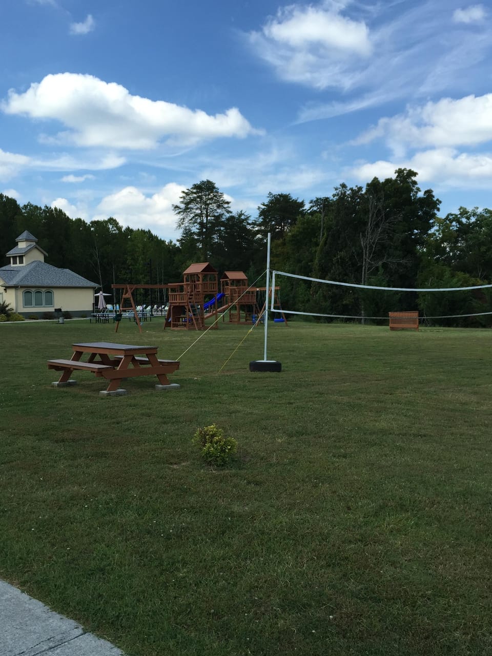 Playground Area that includes Corn Hole and Basketball Court