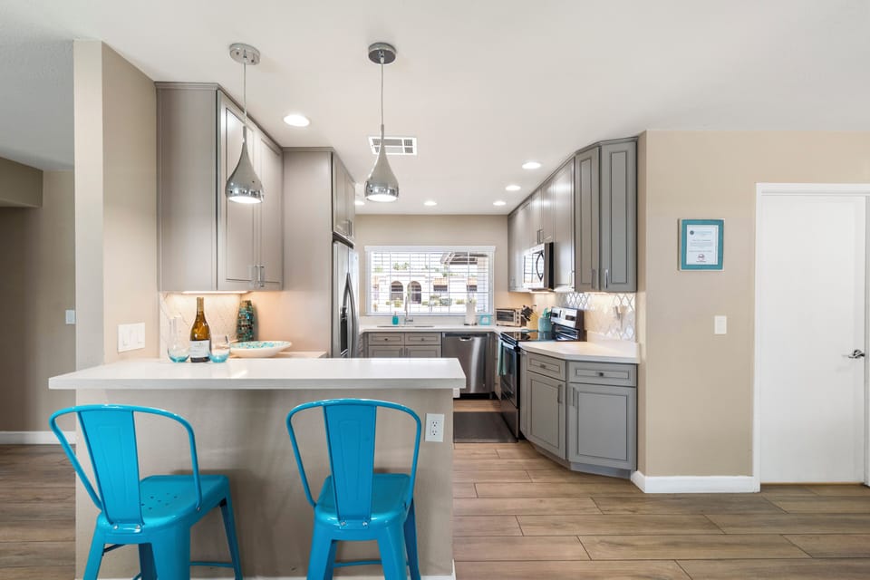 Modern Kitchen with white quartz countertops and Stainless appliances