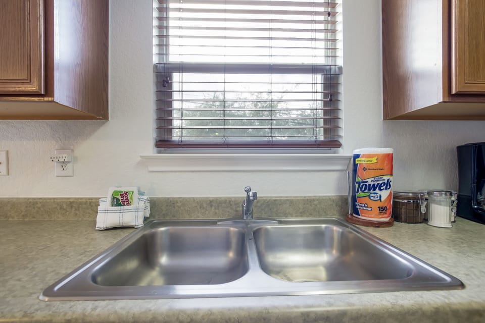 Close up of some amenities; fresh paper towels and dish sponge for every guest