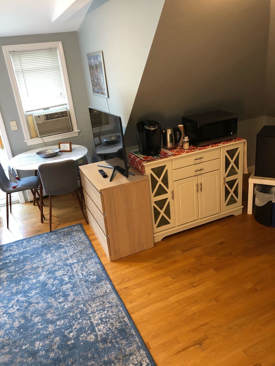 Dining area and pantry area with coffe maker, microwave, kettle and mini fridge 