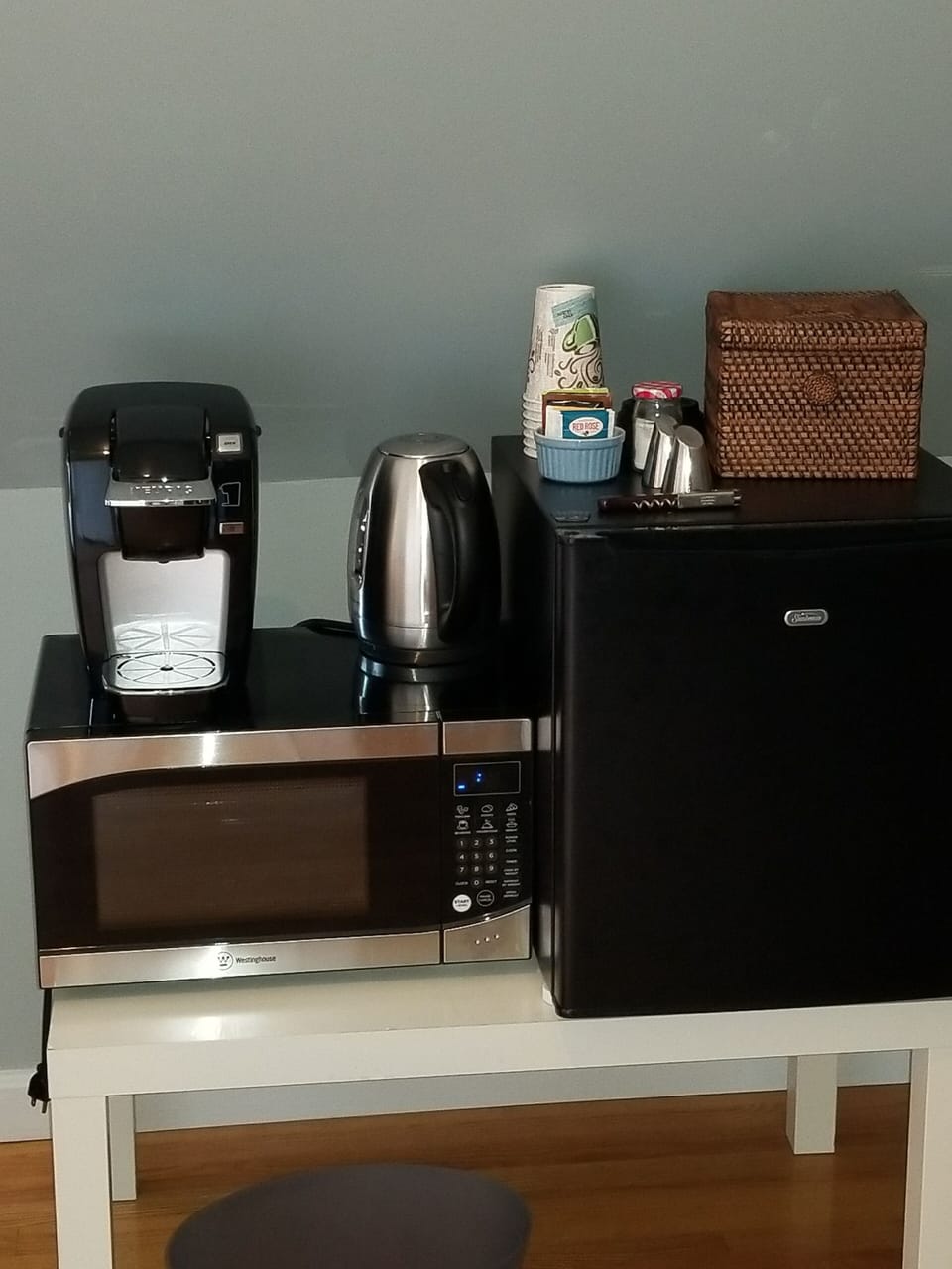  Refrigerator, microwave, Kuerig coffee maker and kettle.