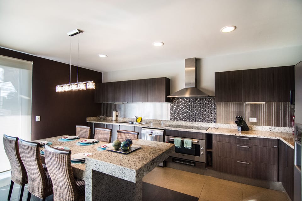 The kitchen is open to the living room, terrace and the BBQ on the terrace !
