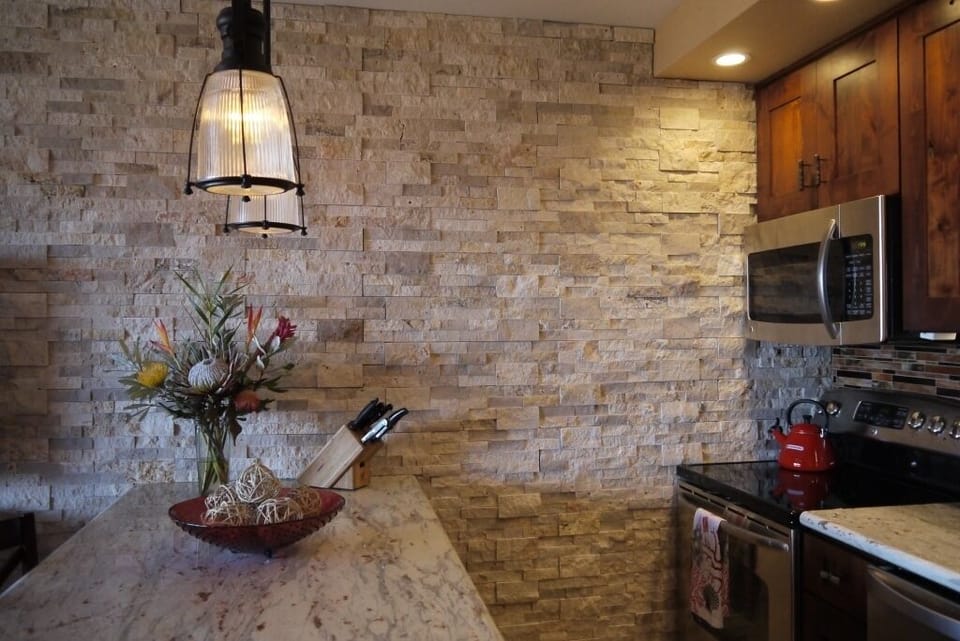 Gorgeous kitchen with stone accent wall and stainless steel appliances