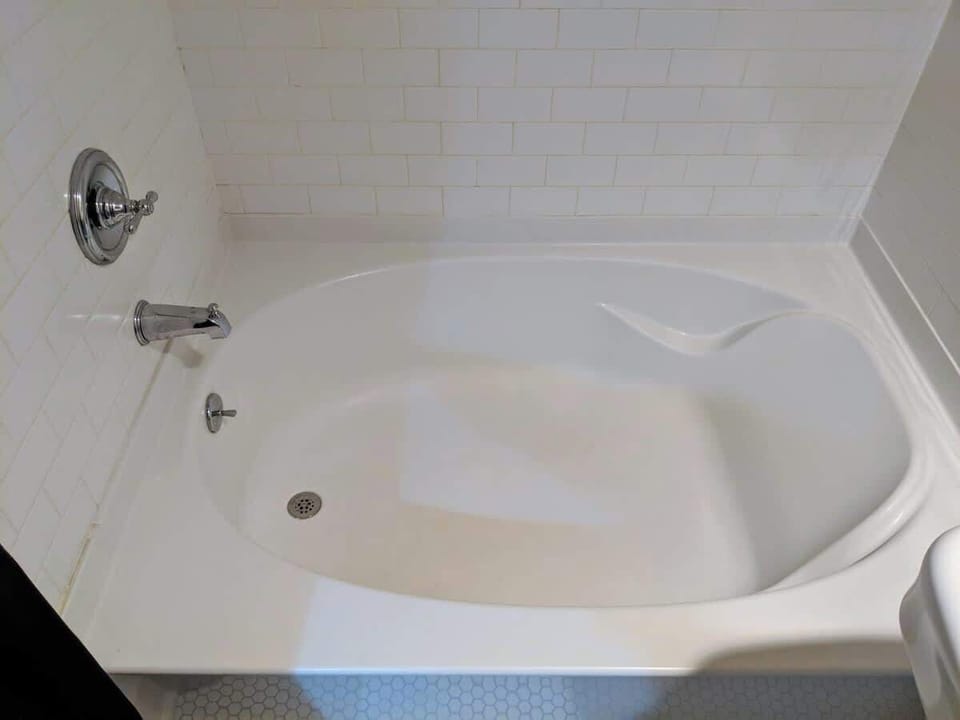 Hallway bathroom has full sized tub/shower combo