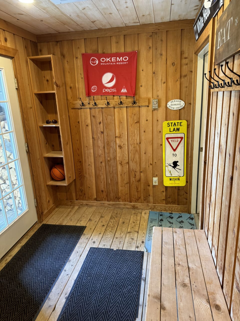 2nd view of mudroom showing more hooks and storage.