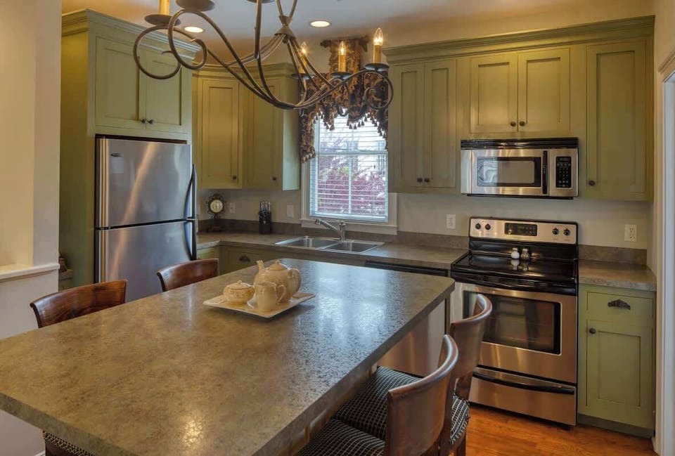 The fully outfitted kitchen has all appliances including a dishwasher & microwave & seating for 4 at the bar top.