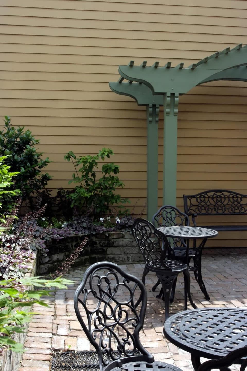 Lush walled courtyard with lots of seating