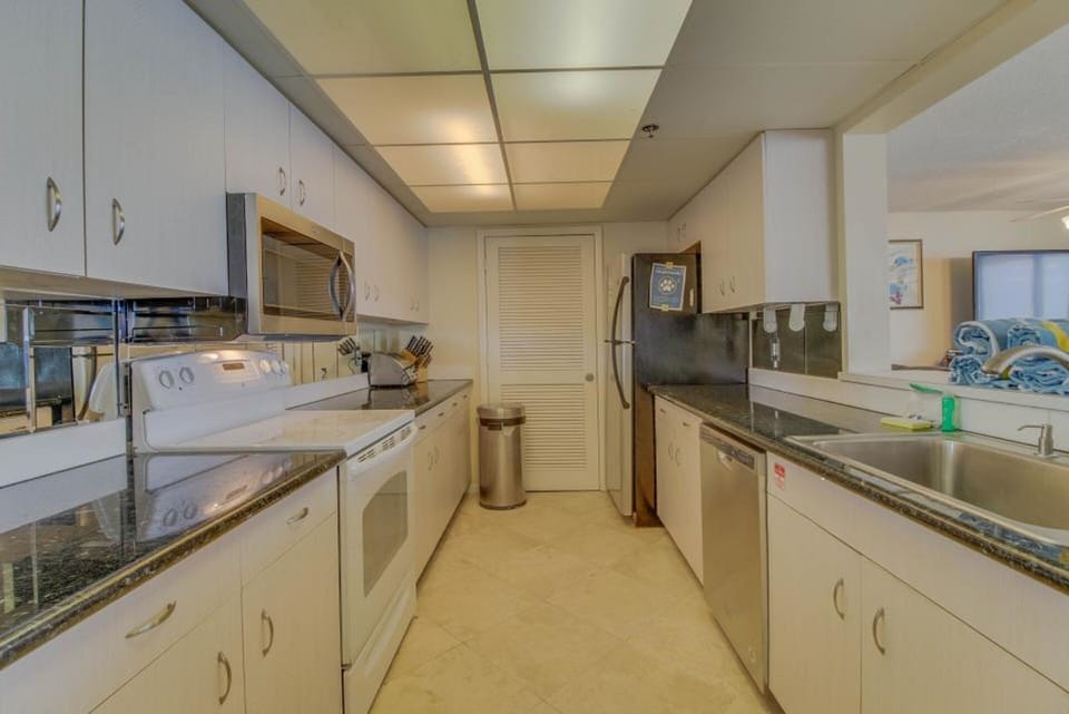 Huge kitchen with new stainless steel dishwasher, microwave and convection oven.