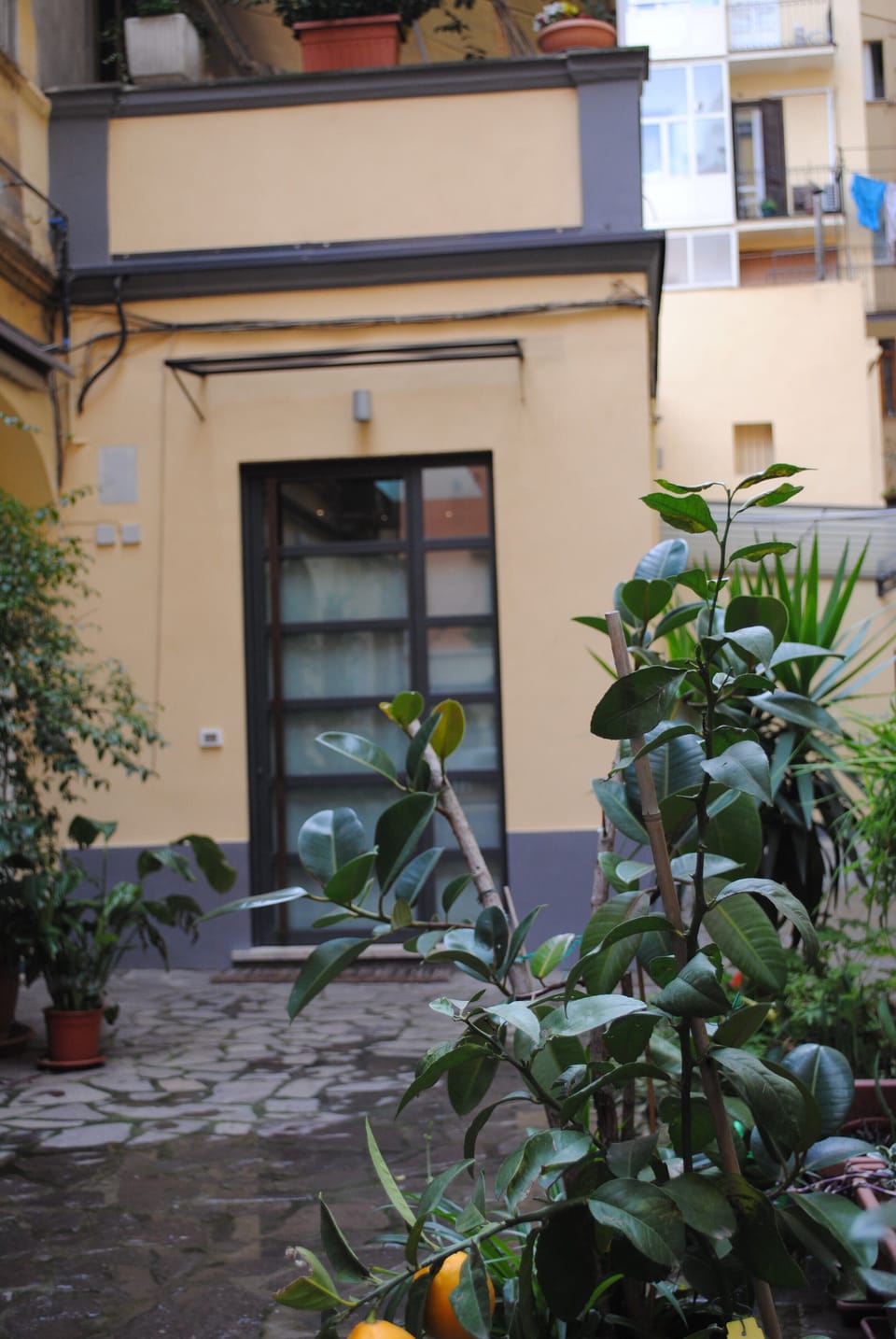 Loft entrance in a calm and sunny courtyard
