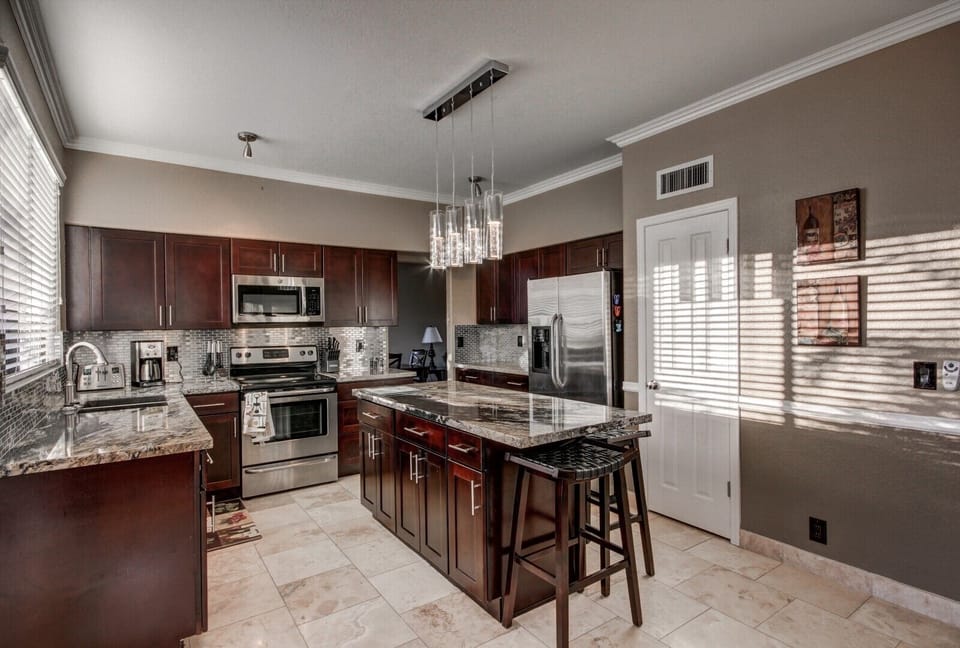 New kitchen - entertaining granite counters & island and stainless backsplash