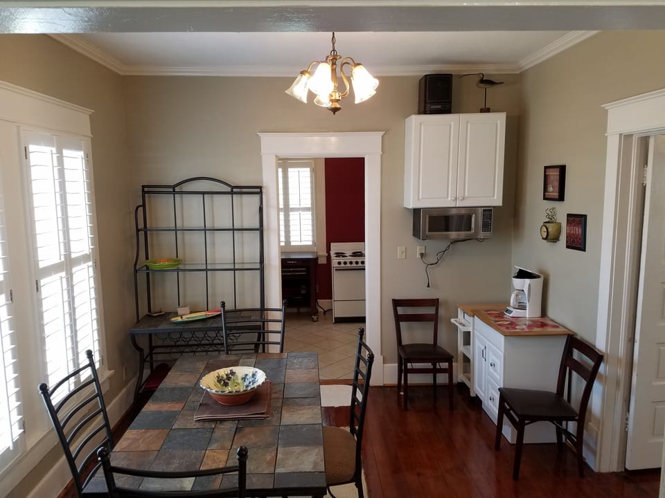 Dining room. Large table (8-10.) Microwave, coffee makers, Board games. Blender