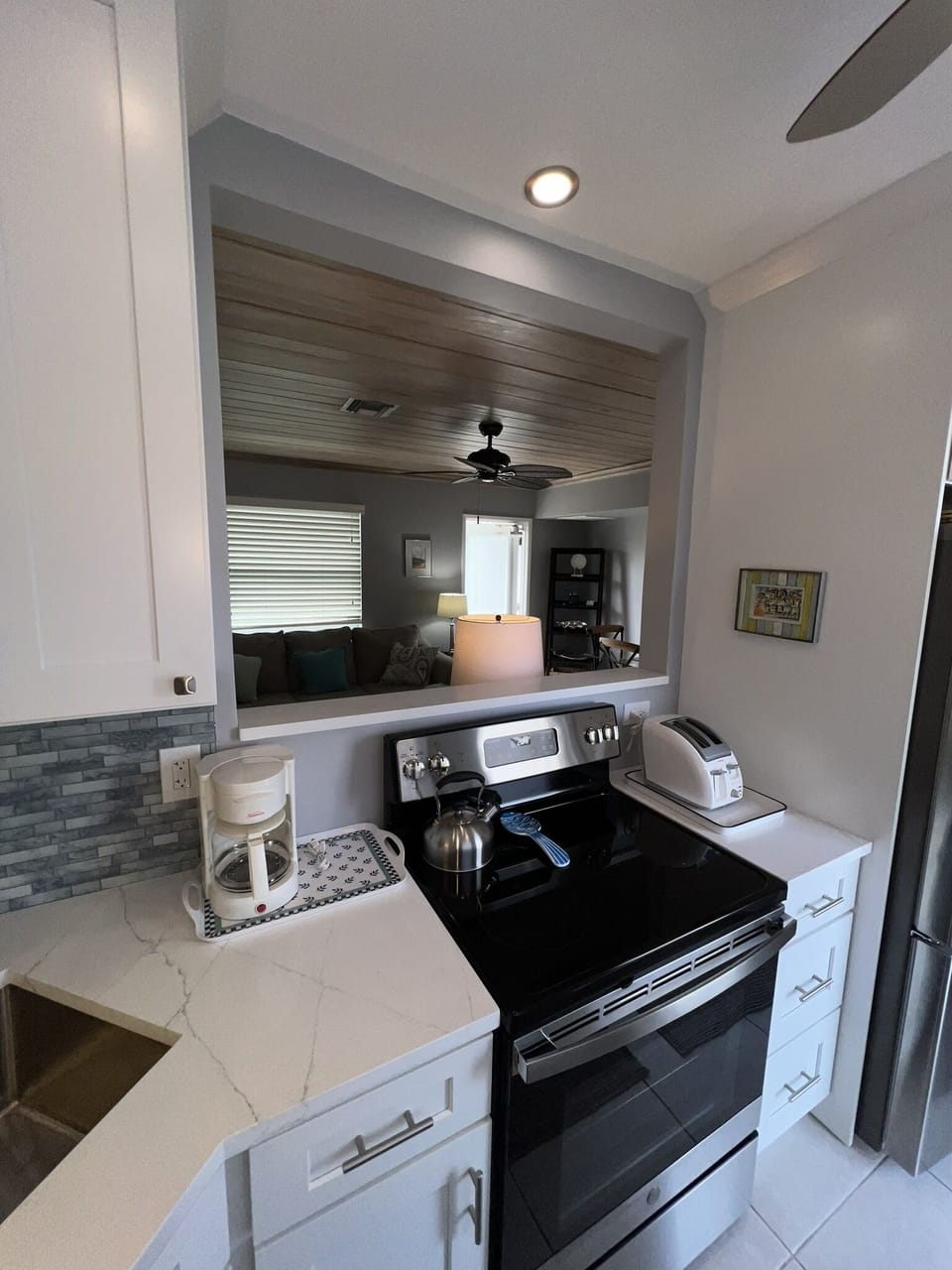Kitchen, microwave, pots & pans, dishes, silverware, glasses, cups.