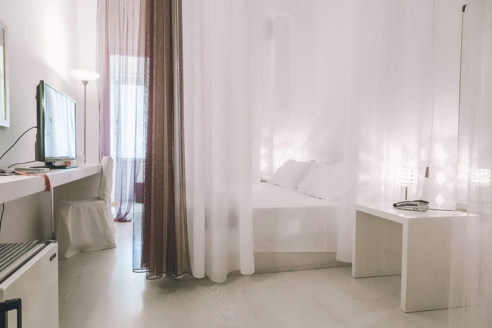 Standard Double Room | Minibar, in-room safe, desk, blackout drapes