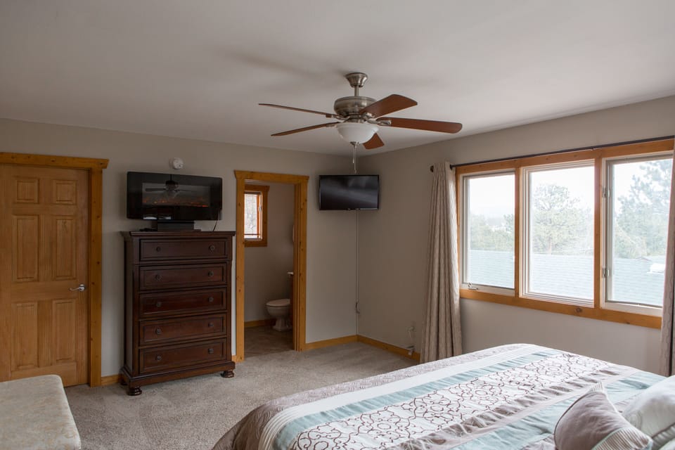 Master Bedroom With Electric Fireplace and 32" Smart T.V.