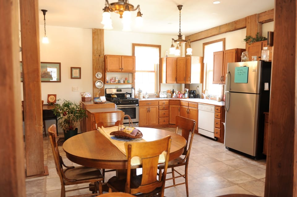 Oak table has leaves to seat 12.
Island near stove is on wheels.