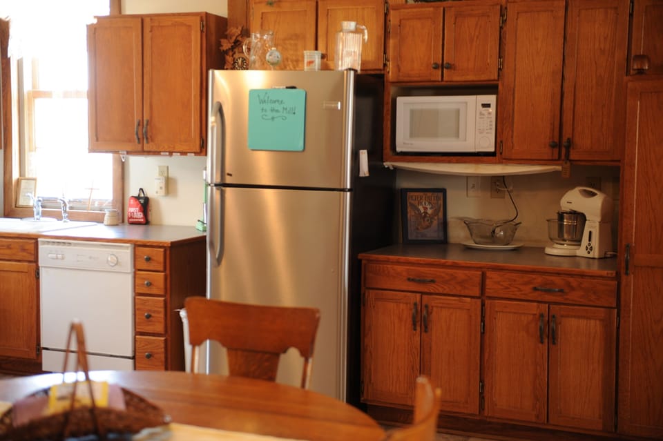 Microwave, mixer, blender station to right of refrigerator.
