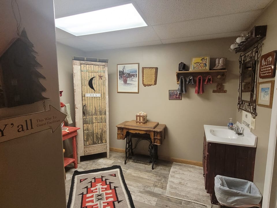 Downstairs bathroom sink area separate from toilet and shower