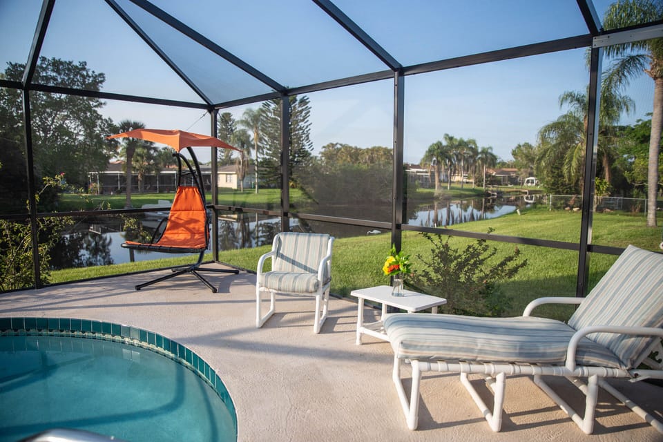 Lounge areas by the pool with canal in the background