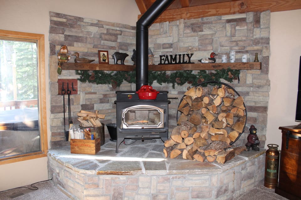 Fireplace with raised hearth for extra seating; wood included year round