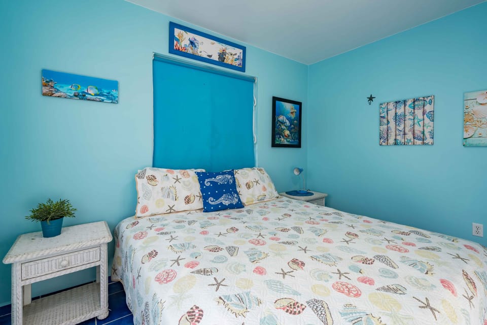 Downstairs blue bedroom with 1 queen bed