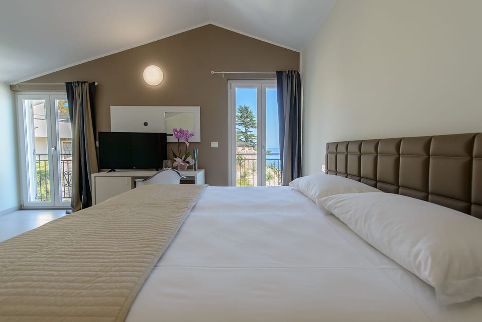 Superior Quadruple Room, Patio, Sea View (Brown) | Minibar, in-room safe, desk, soundproofing