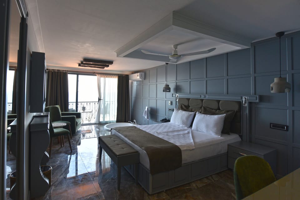 Deluxe Penthouse, 1 Bedroom, Balcony, Sea View | Minibar, in-room safe, individually decorated, desk