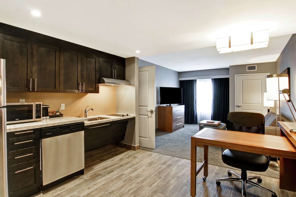 Premium bedding, desk, laptop workspace, blackout drapes