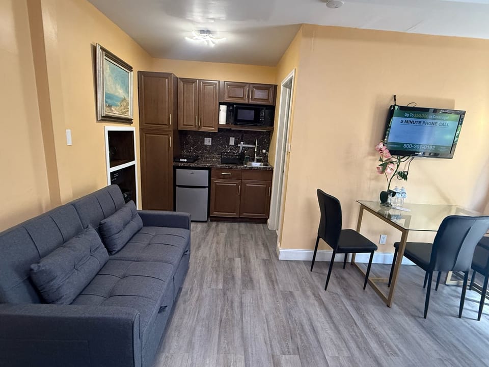 Economy Studio, Multiple Beds, Kitchenette, Garden Area | Living area | 42-inch TV with satellite channels