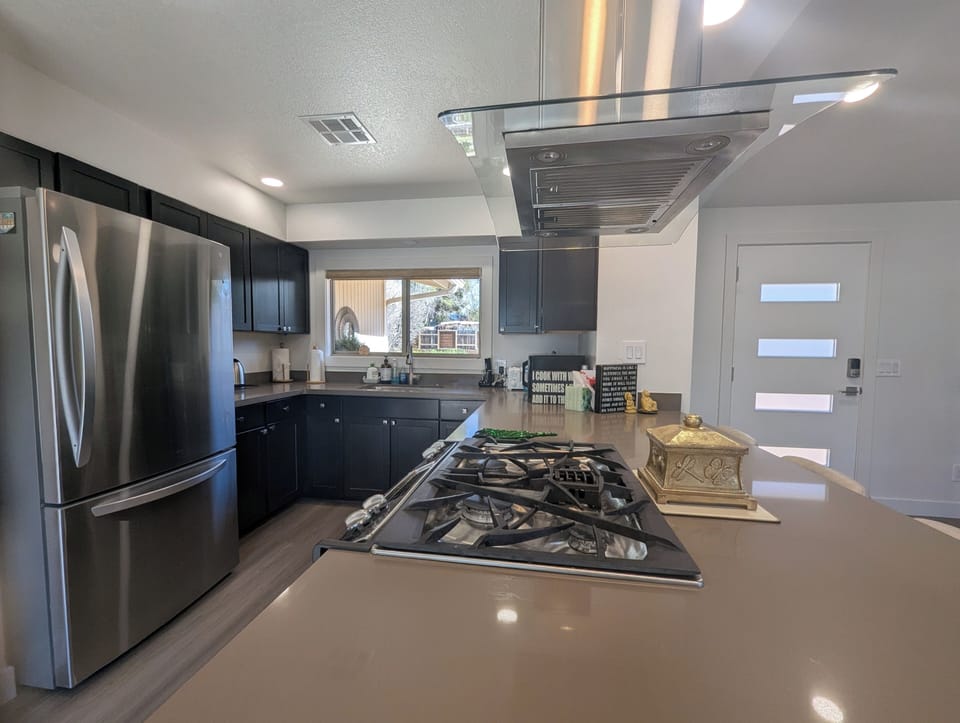 Kitchen with gas range, dishwasher, microwave, fridge freezer, etc.