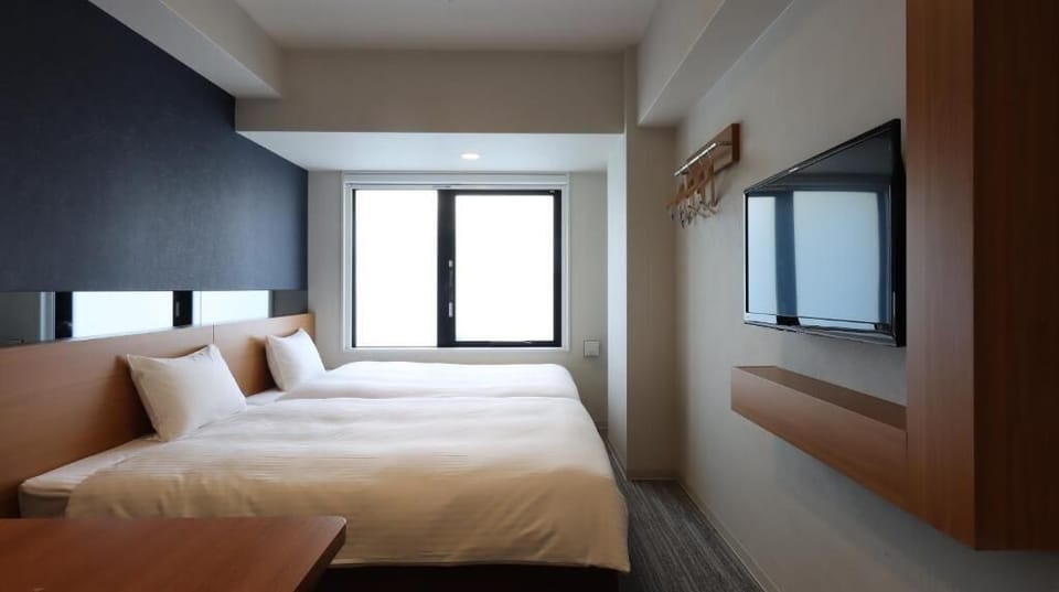 Twin Room | Down comforters, desk, blackout drapes, free WiFi