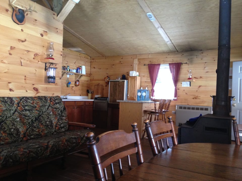 Looking toward the kitchen w/Breakfast Bar, Refrigerator, and Stove.