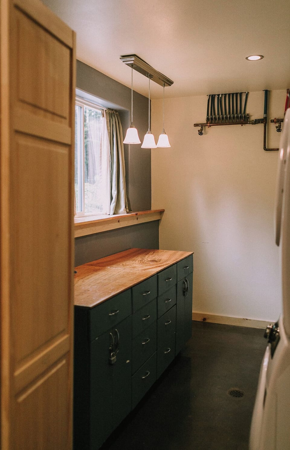 Folding table in the laundry room has plenty of space and light.