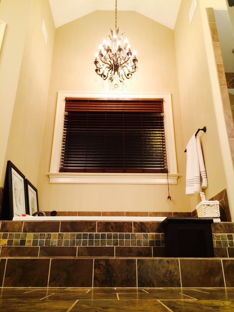 Ceiling soars to 16'! Jacuzzi tub is lit by two-tier, bronze/crystal chandelier.