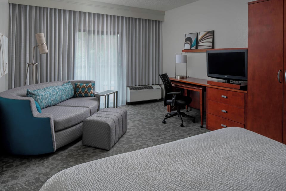 Premium bedding, desk, laptop workspace, iron/ironing board
