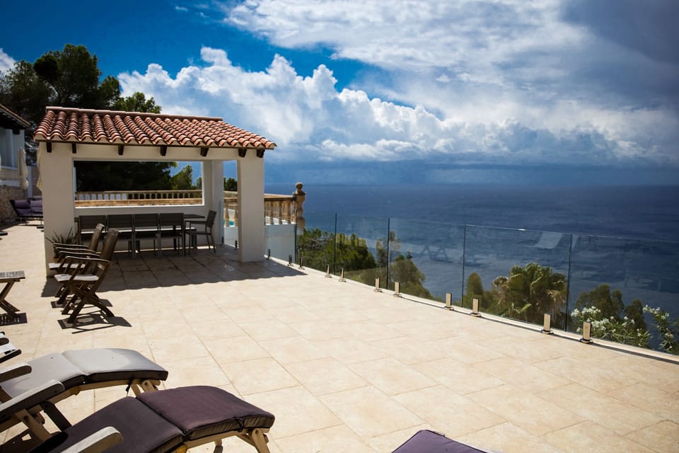 Large terrace with sun beds and steamer chairs