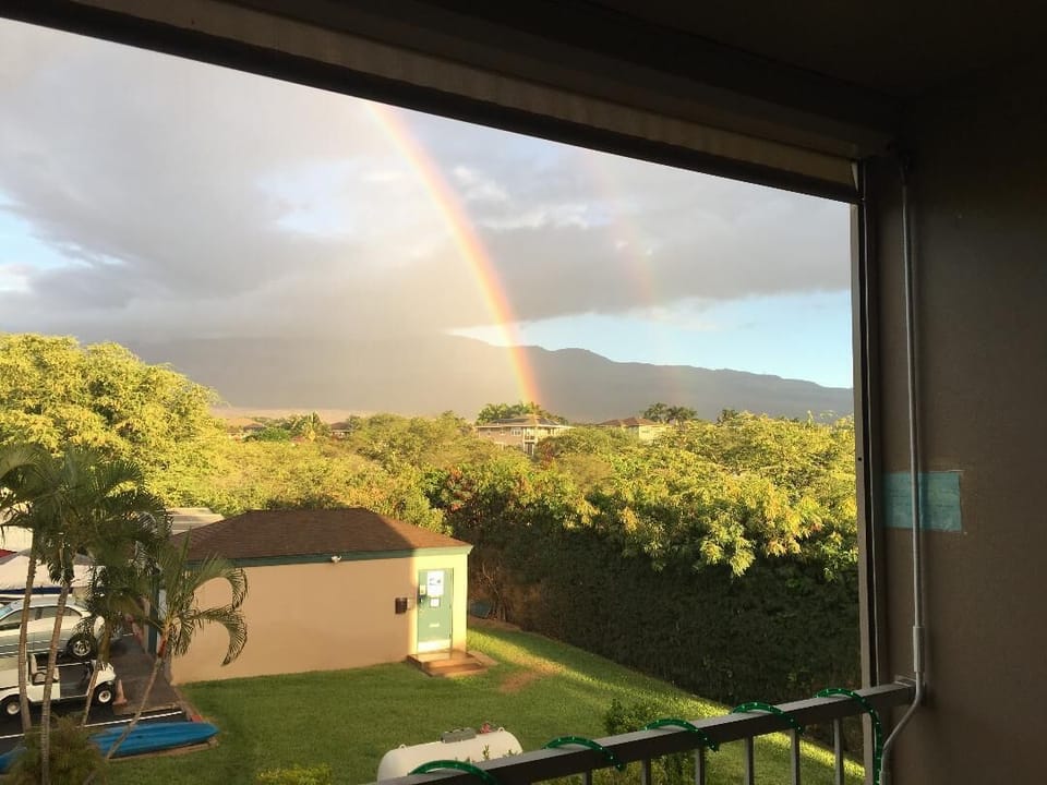 Rainbow view from our condo. Moon rises over Mt. Haleakala.