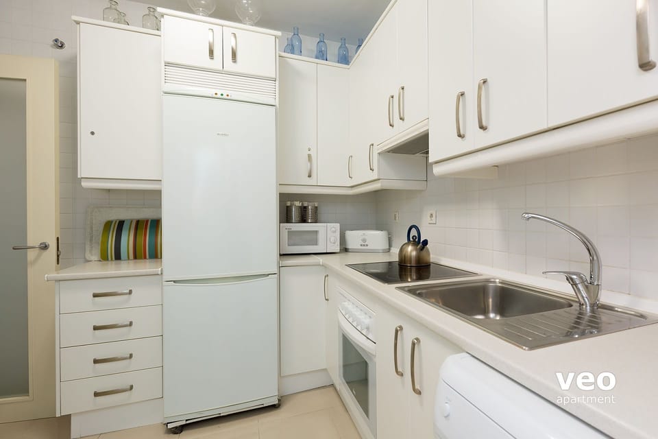 Large kitchen with oven, dishwasher and washing machine.