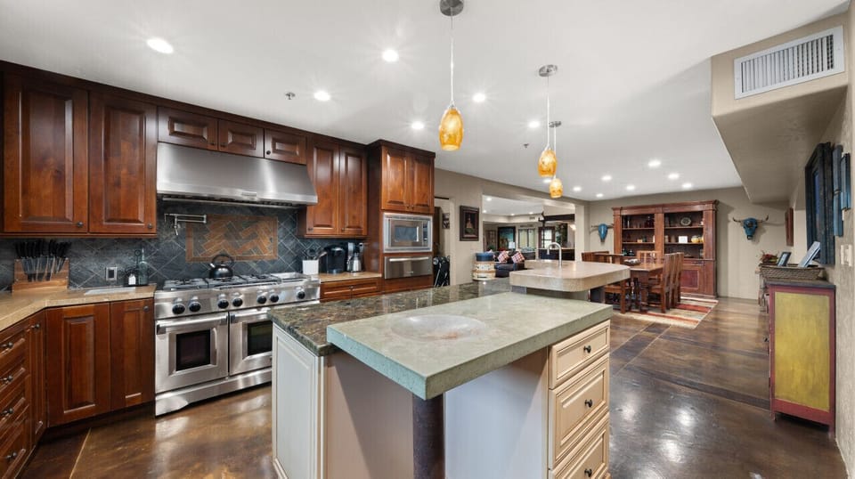 [Kitchen] Well stocked and fully equipped gourmet chef`s kitchen with a 6-burner gas stove, double ovens, large side by side refrigerator/freezer, warming drawer, microwave, & dishwasher