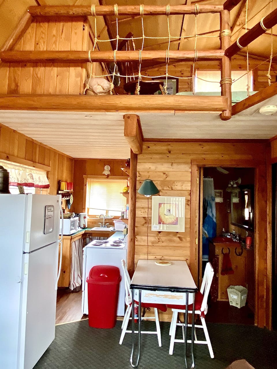 View of the kitchen and entrance to the bathroom from the front of the cabin.