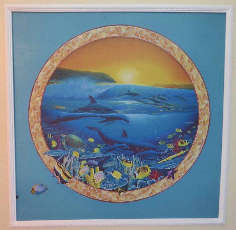 Beautifully painted sea life wall mural framed by the bathroom vanity.  