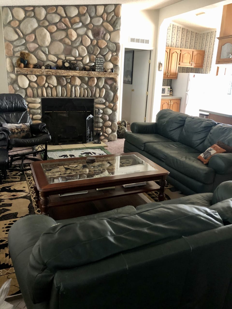 Comfortable seating in the living room with natural wood burning fireplace=Cozy.