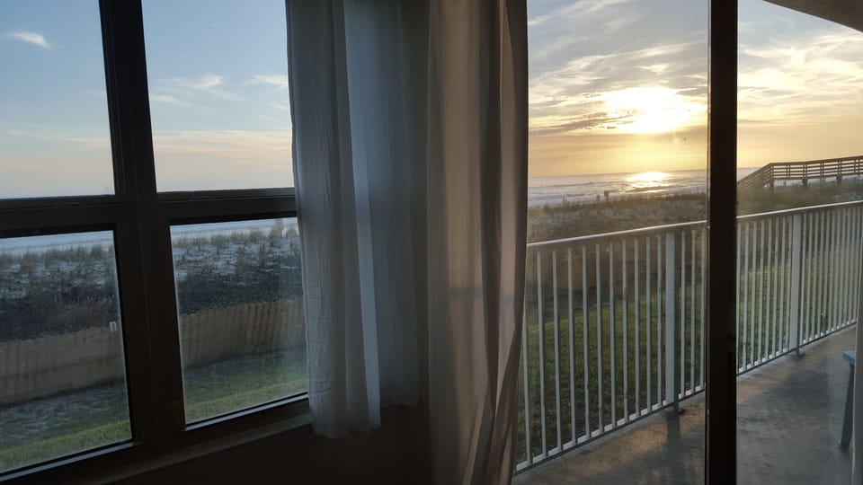 Master Bedroom View At Sunset with Sliding Glass Door to Patio